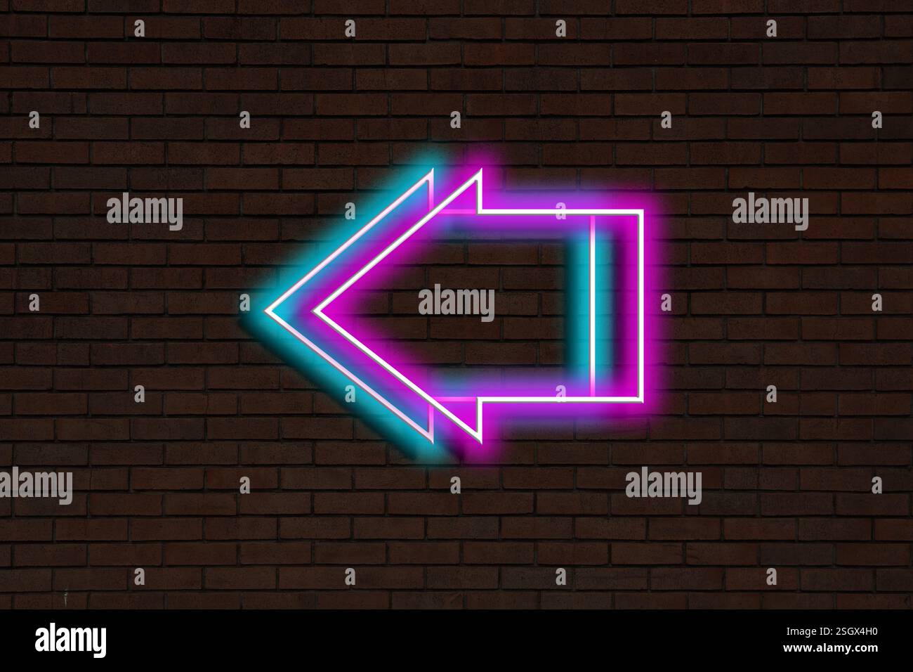 Bright neon arrow-shaped pointer on brick wall Stock Photo