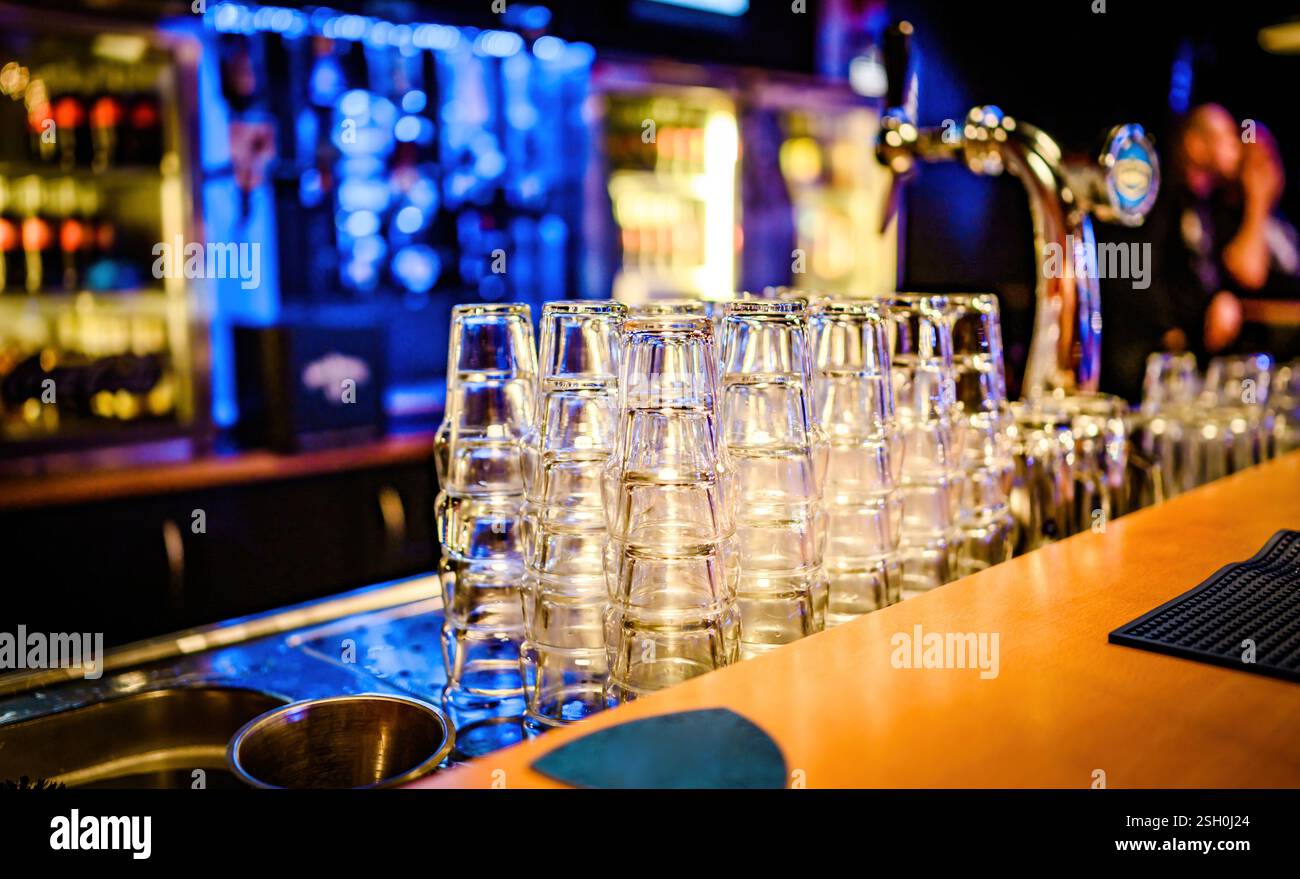 Stylish night bar counter with glasses and lights. Modern pub nightclub ...