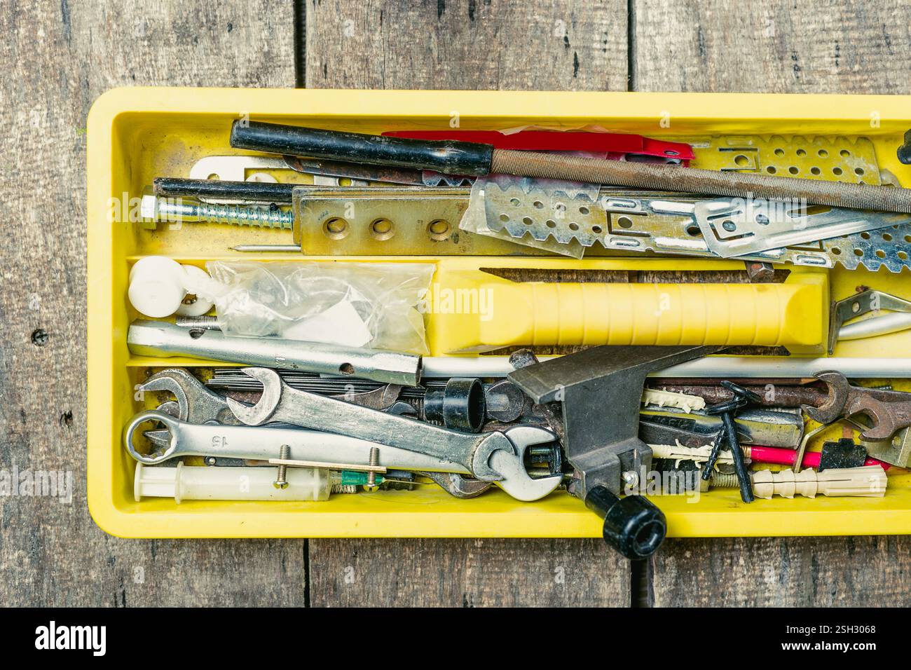 Tool box filled with various tools and implements on a rustic wooden ...