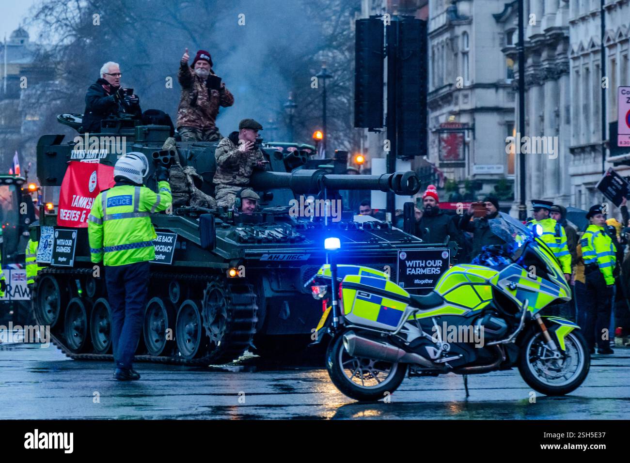 London, UK. 10th Feb, 2025. At the end of the day the tractors (and an Abbot self propelled gun) leave, marshalled by the Police, as the wet weather arrives - Hundreds of tractors arrive in Whitehall. Farmers continue to protest against Rachel Reeves' decision to impose Inheritance Tax (IHT) on all farms, worth over £1 Million, which they believe 'has put British Farmers into a perilous position'. Credit: Guy Bell/Alamy Live News Stock Photo