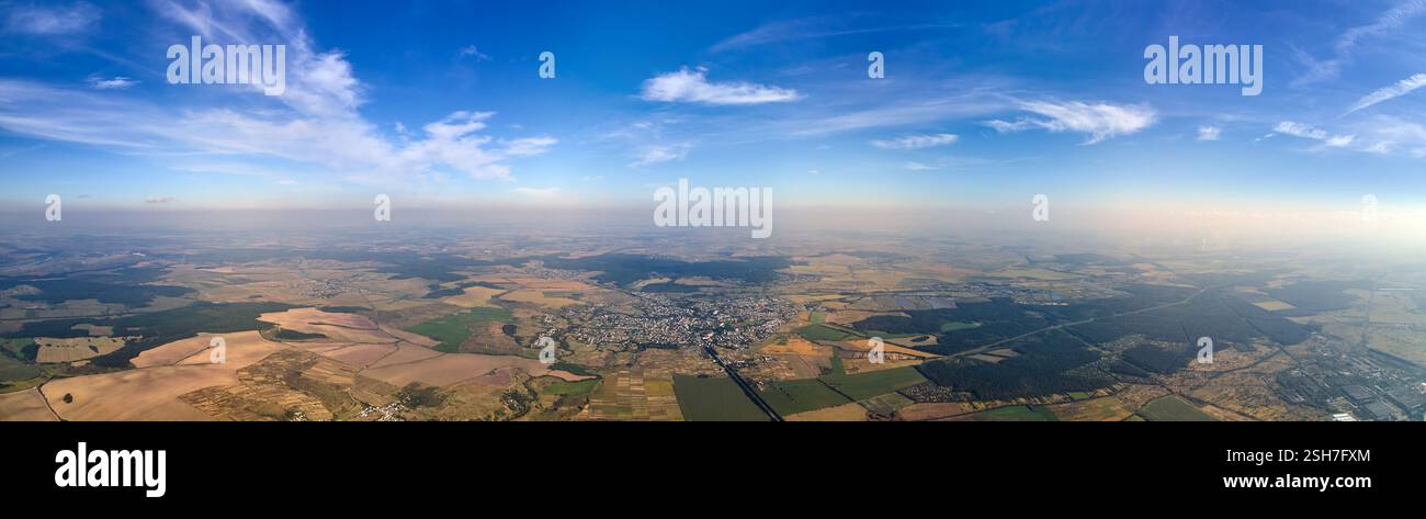 Aerial view of farm fields and distant scattered houses in rural area ...