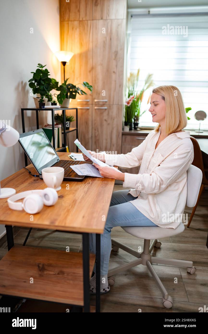 Engaging work session in a bright home office filled with greenery Stock Photo