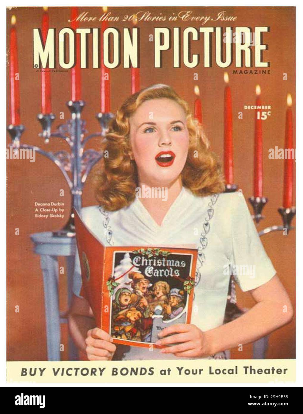 1945 December Motion Picture magazine Christmas cover feat Deanna Durbin holding Christmas Carols Canadian-American singer and actress Stock Photo