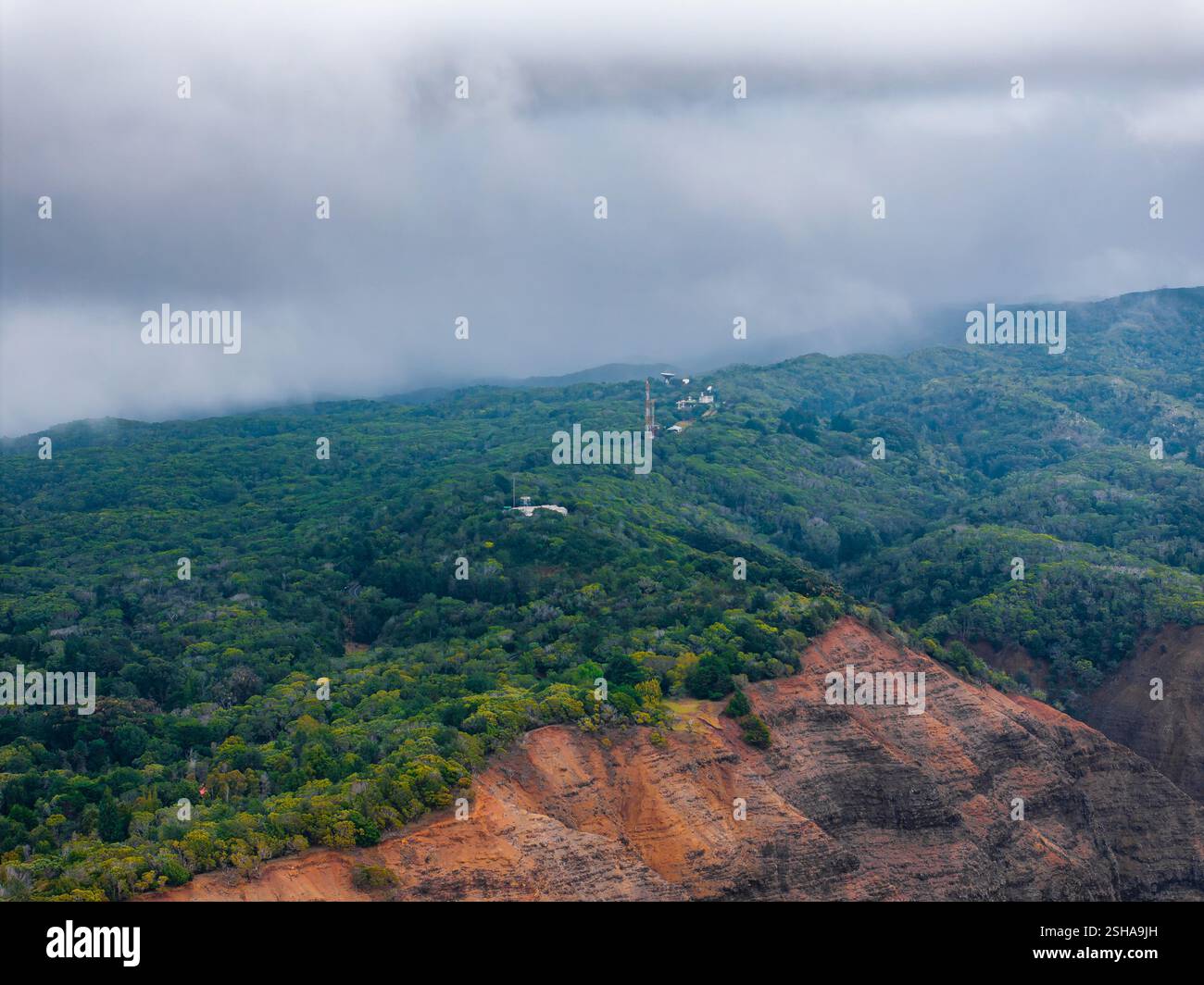Aerial View of Forested Ridge and Cliffs on Kauai Island with Clouds ...