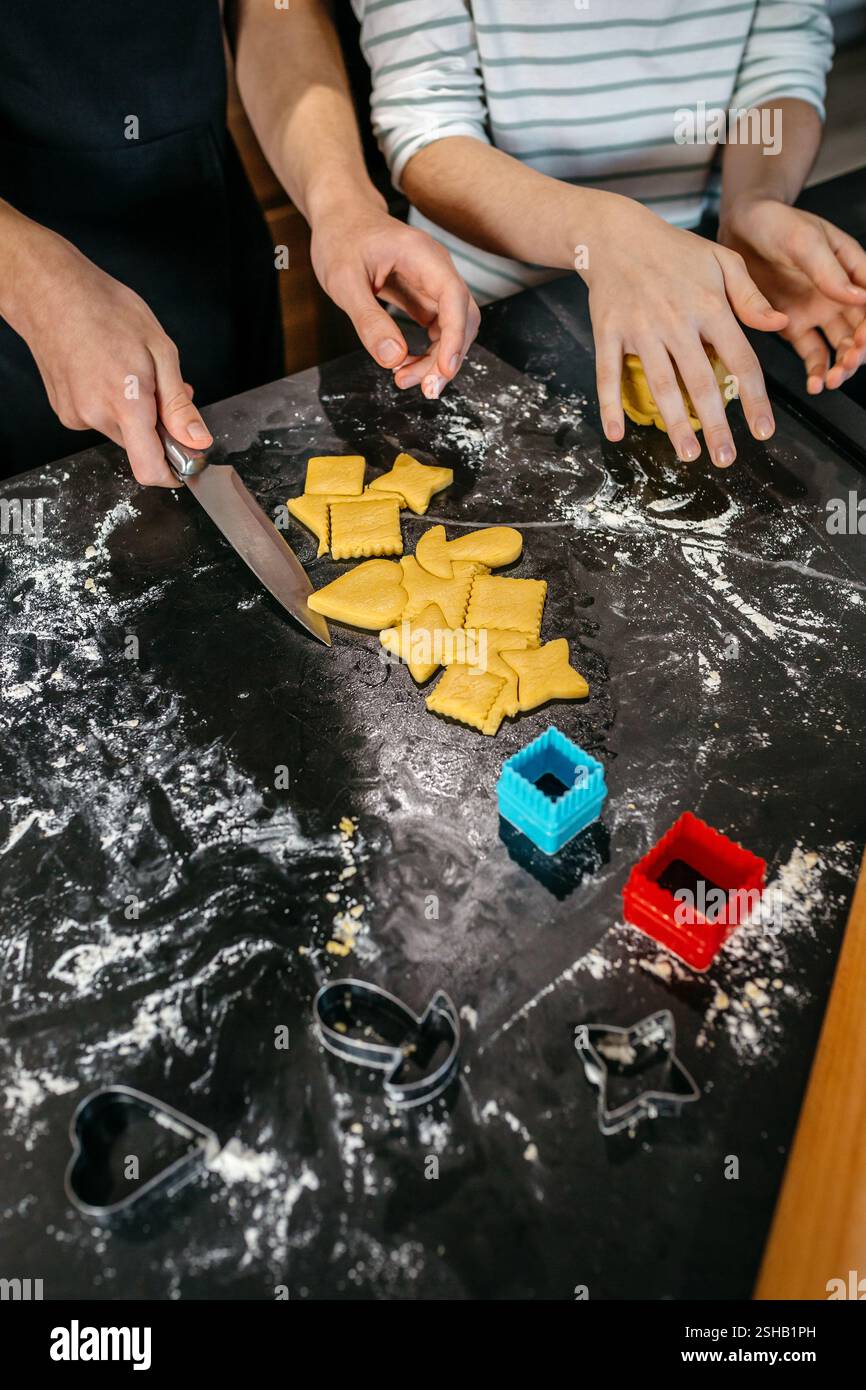 Unrecognizable children making cookies with various forms on a messy ...