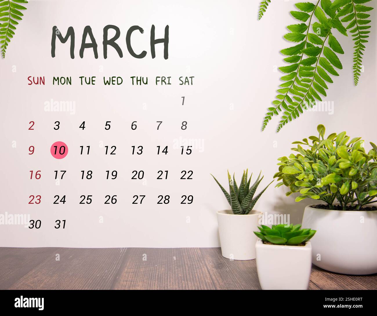 A Wooden calendar blocks showing the date March 10 in Portuguese on a ...