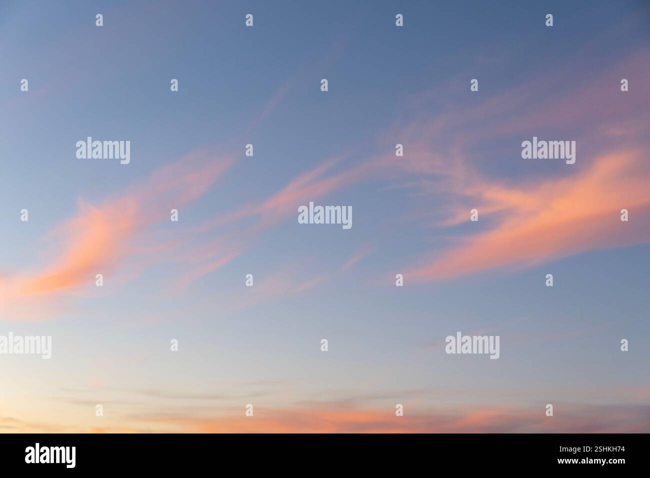 A stunning sunset sky with soft, wispy clouds painted in delicate ...