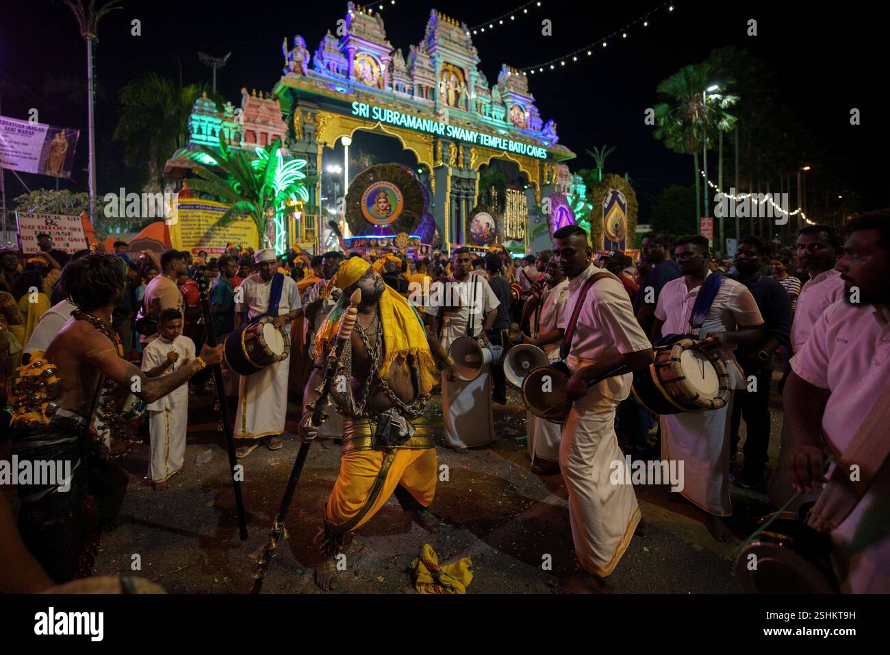 Hindu devotees perform a procession as they walk in the Sri ...