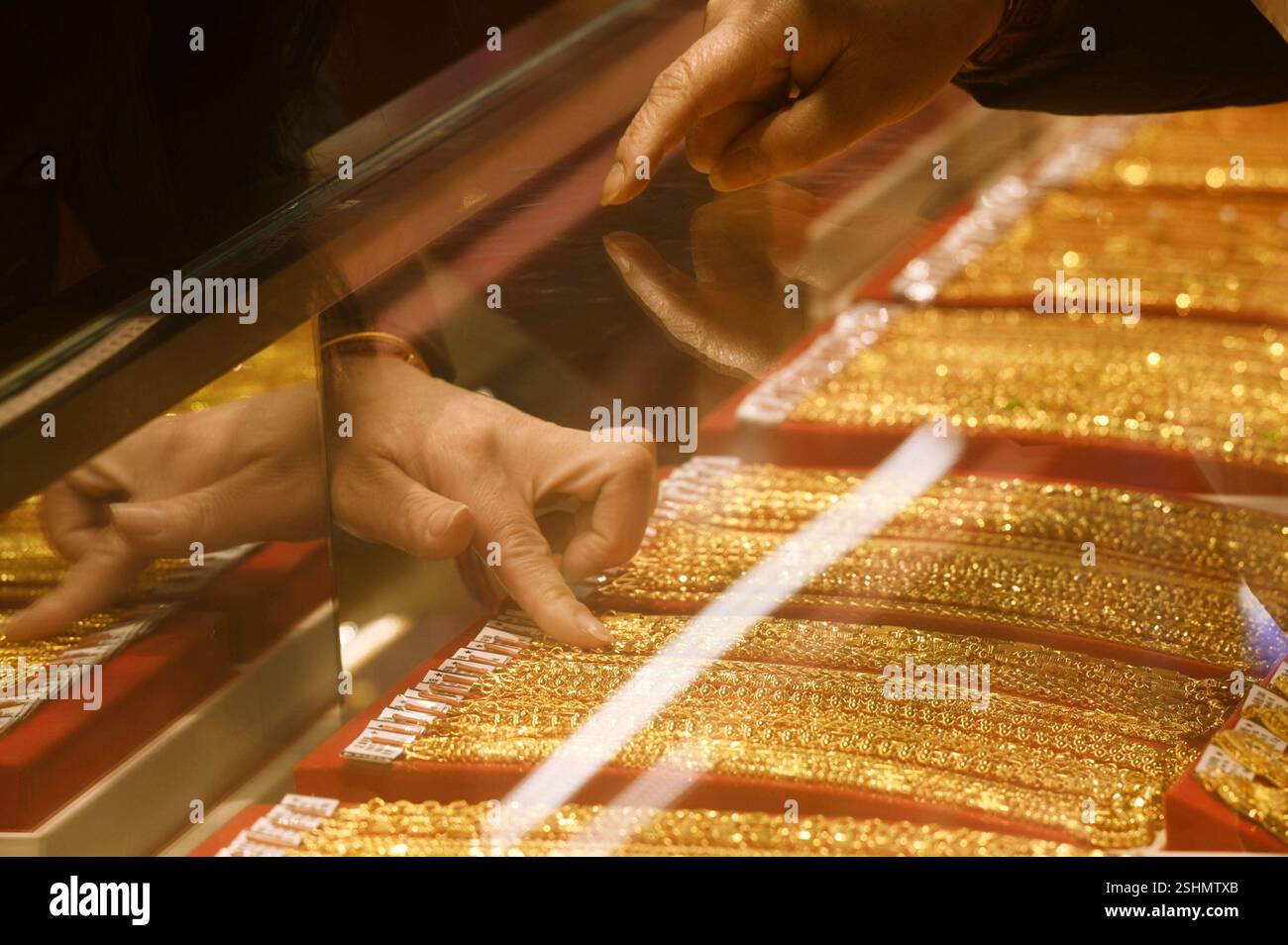 A customer buys gold jewelry at a gold store in Hangzhou, east China's ...