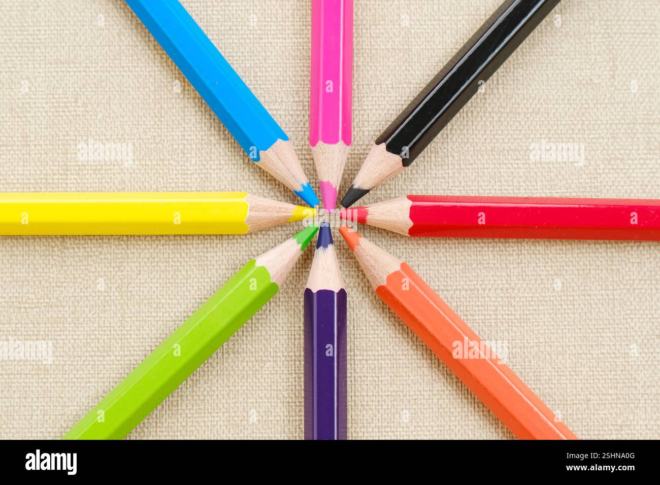 Colorful sharpened pencils are lined up on the table. Flat lay Stock Photo