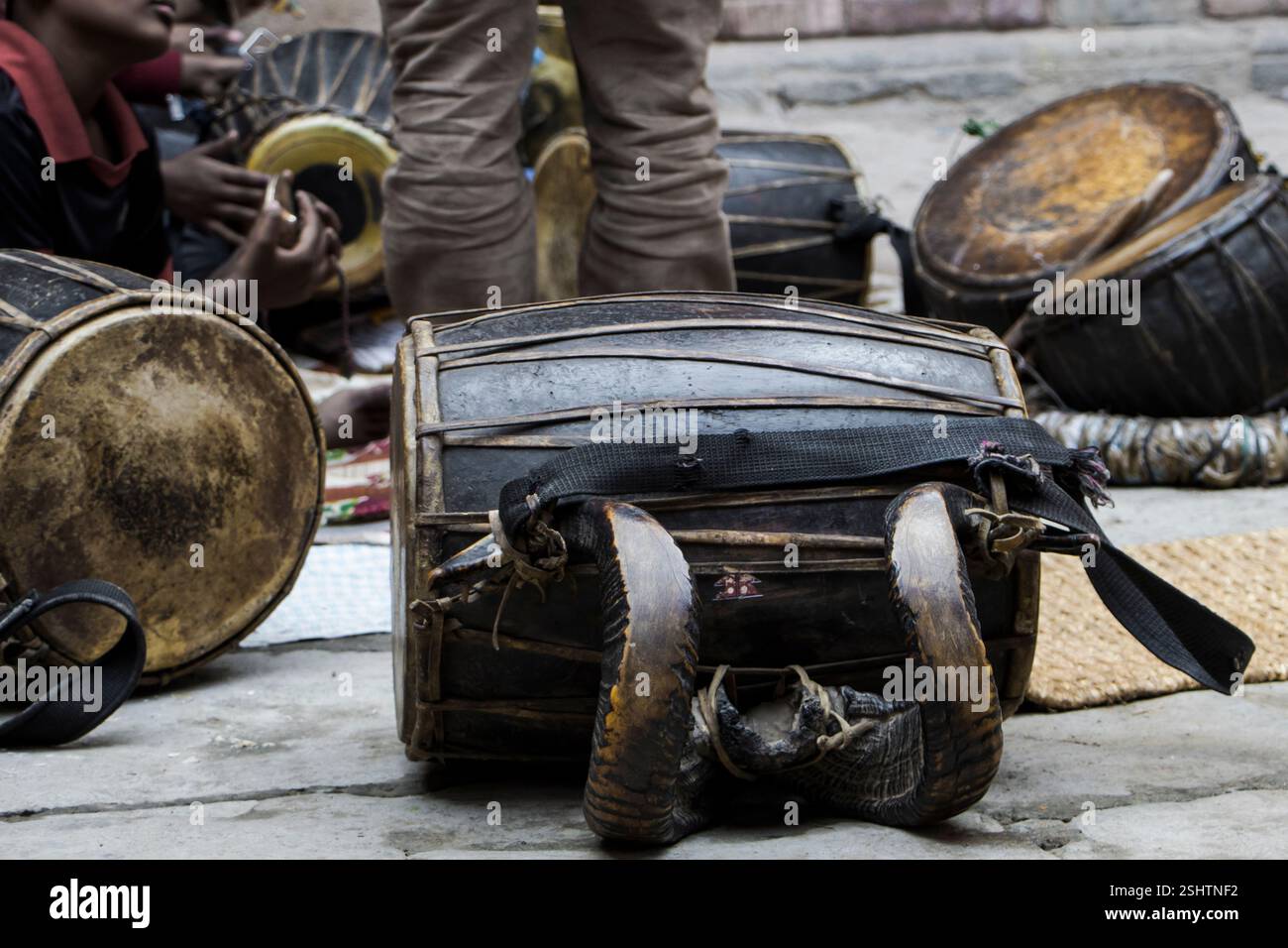 A Double Headed Drum with sheep horns attached to it. The Dhaa: is one ...