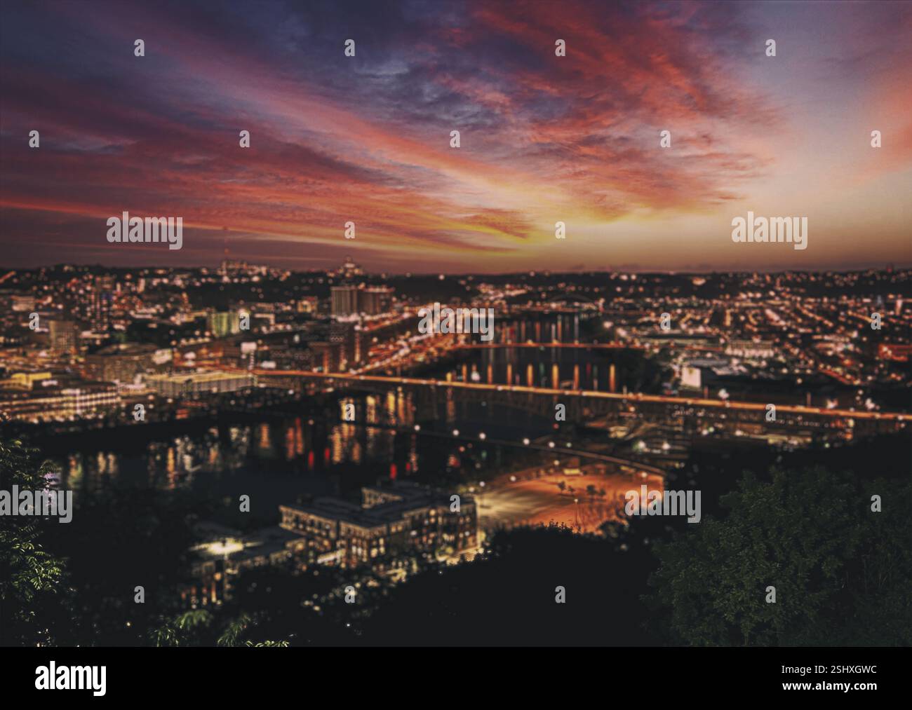 Pittsburgh, Pennsylvania, USA skyline at dawn. City skyline at night with a beautiful sunset in the background. The city is lit up with lights and the Stock Photo