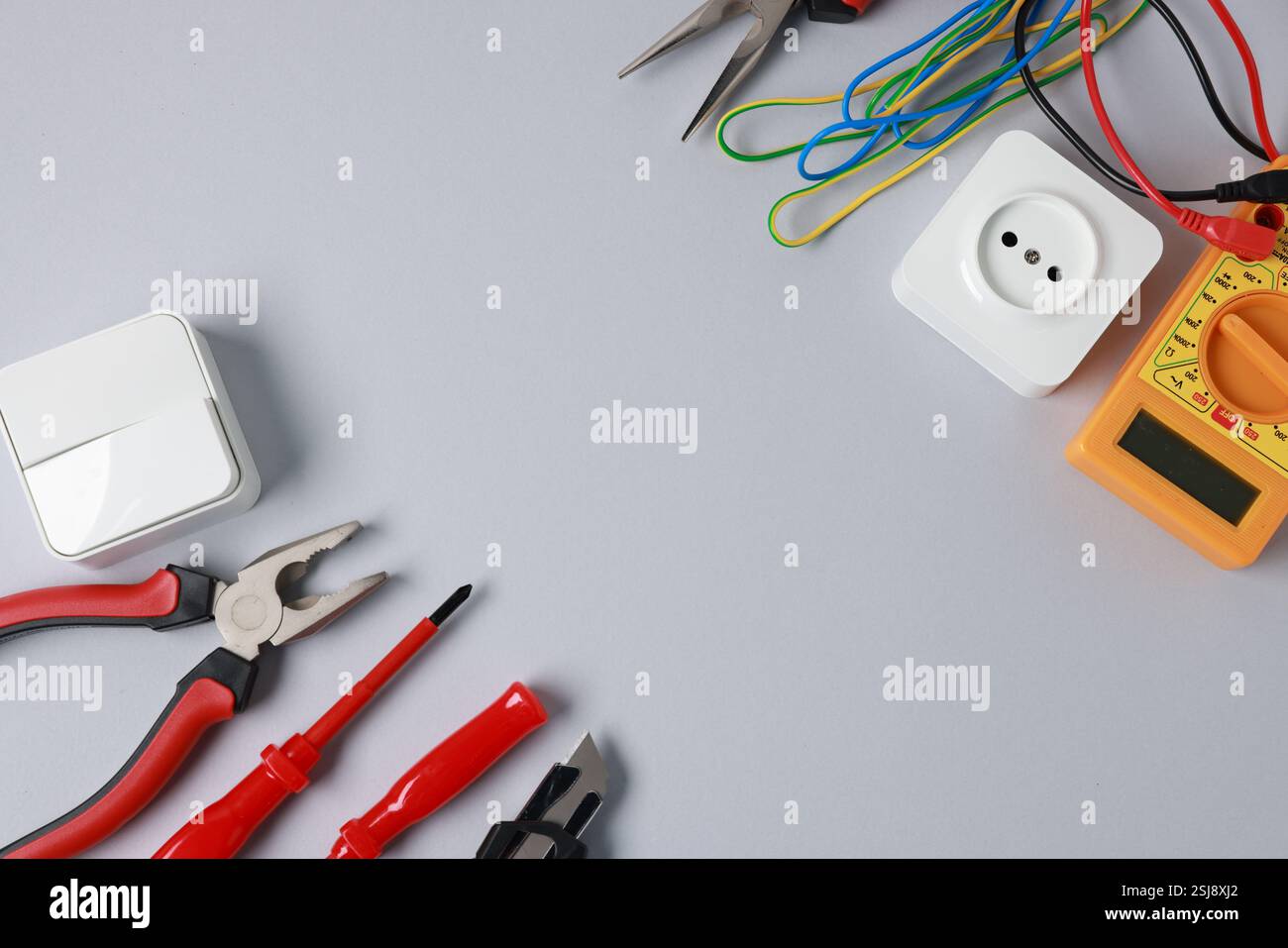 Different electrical tools on grey background, flat lay. Space for text Stock Photo
