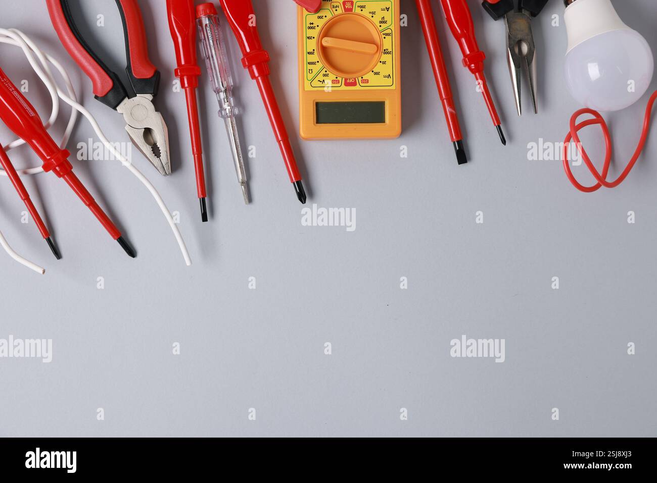 Different electrical tools on grey background, flat lay. Space for text Stock Photo