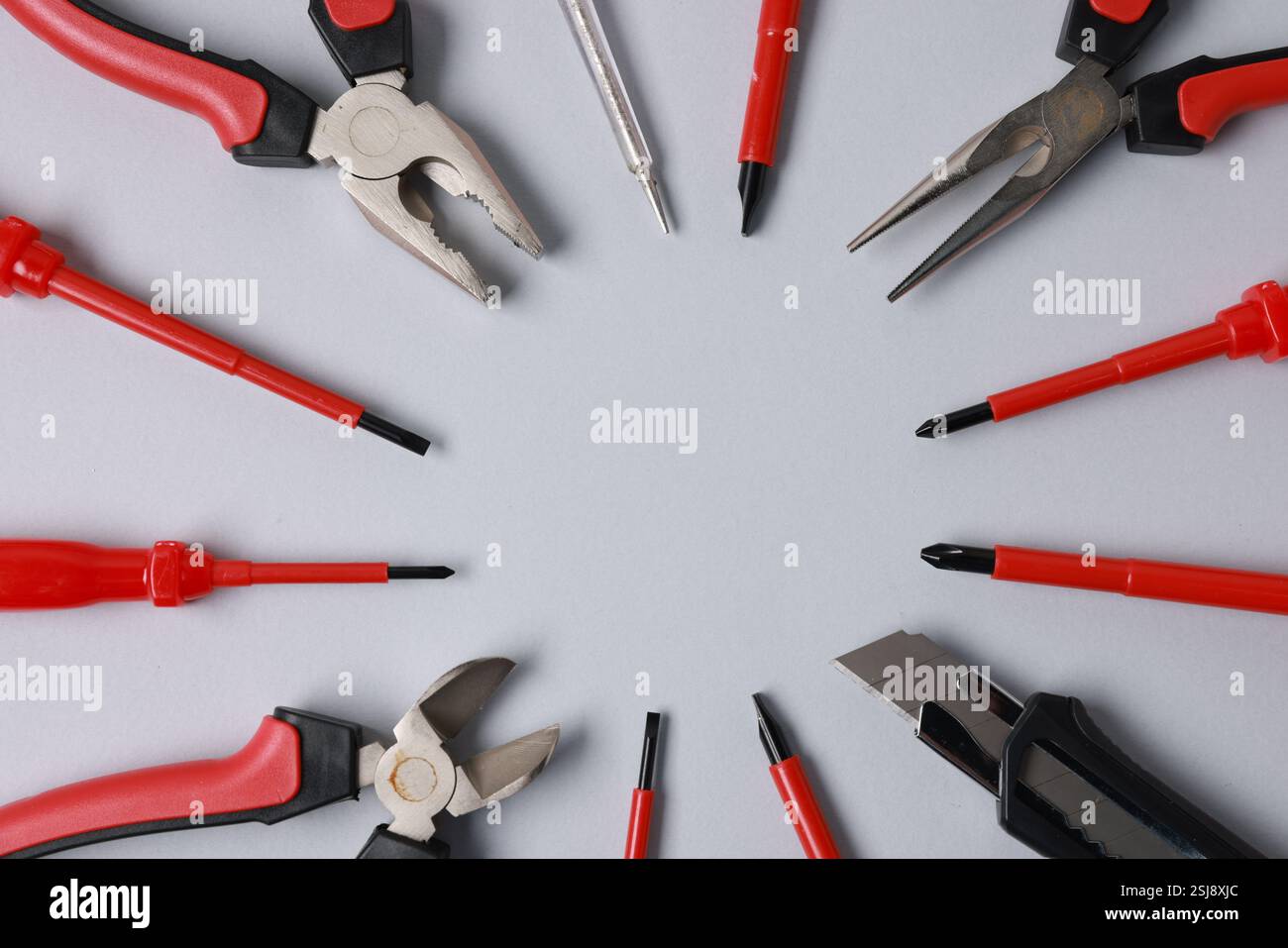 Frame of different electrical tools on grey background, flat lay. Space for text Stock Photo
