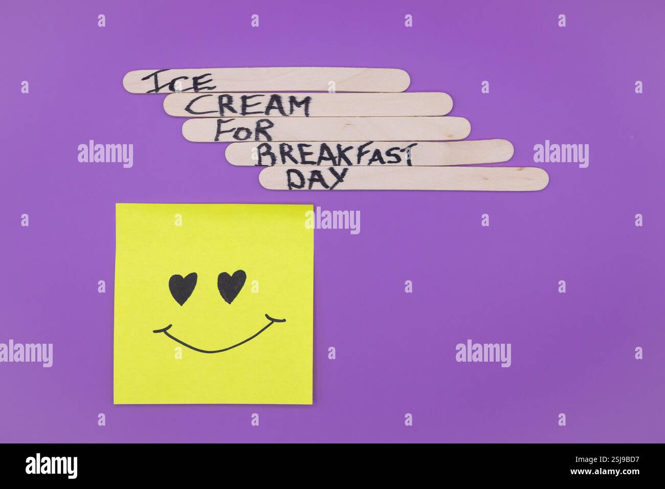A concept of handwritten popsicle sticks on a purple background and a ...