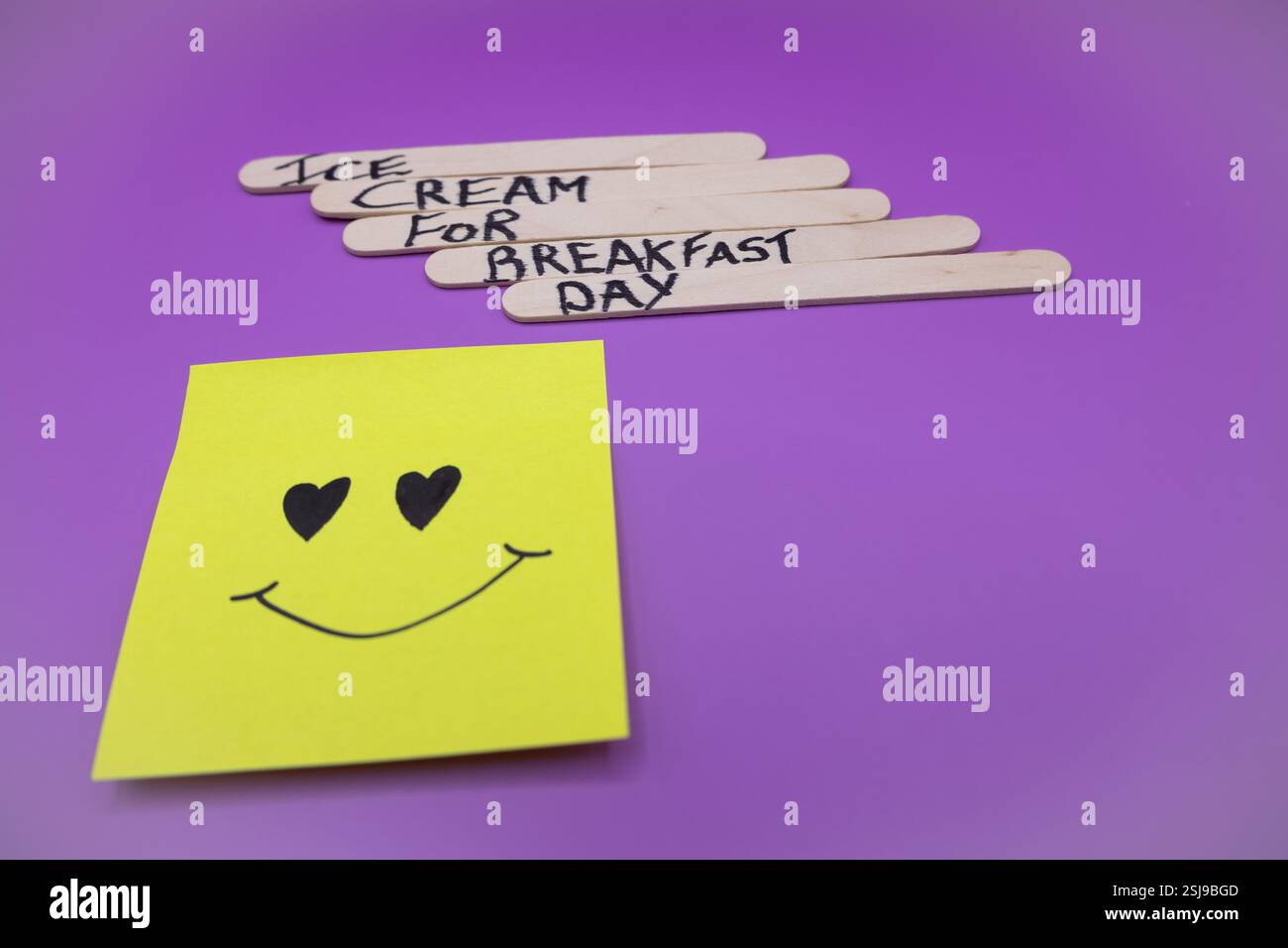 A concept of handwritten popsicle sticks on a purple background and a ...