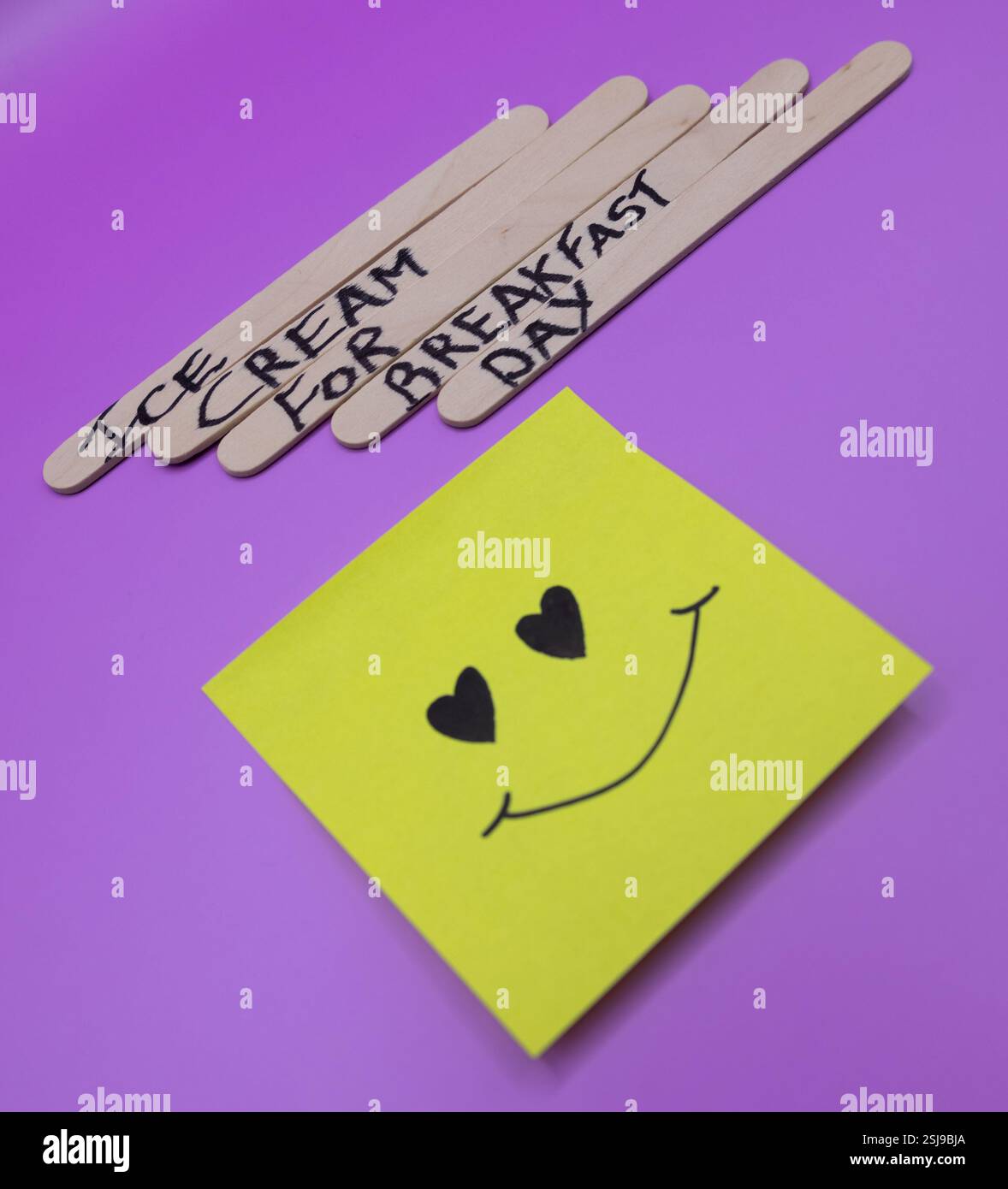 A concept of handwritten popsicle sticks on a purple background and a ...