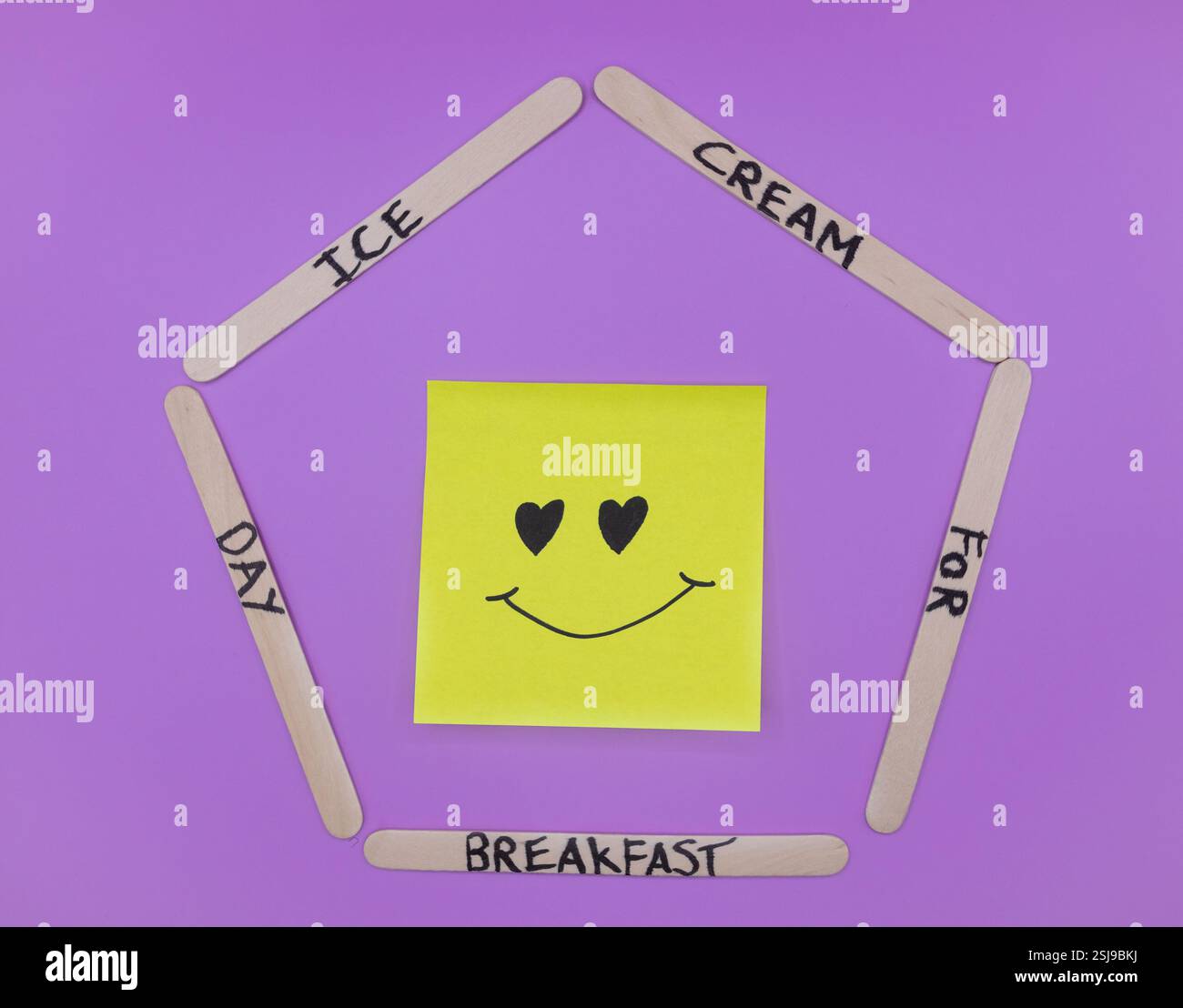 A concept of handwritten popsicle sticks on a purple background and a ...