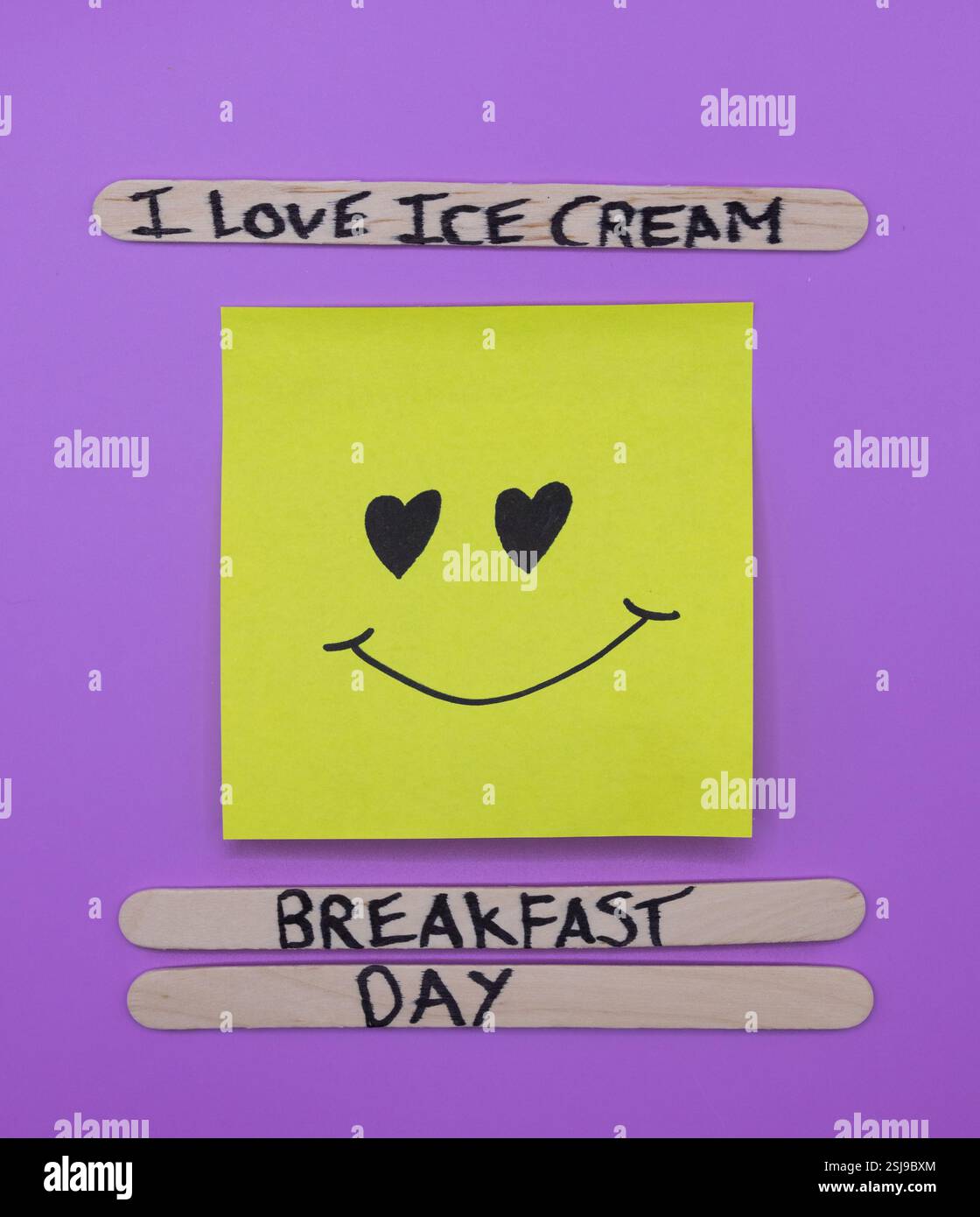 A concept of handwritten popsicle sticks on a purple background and a ...