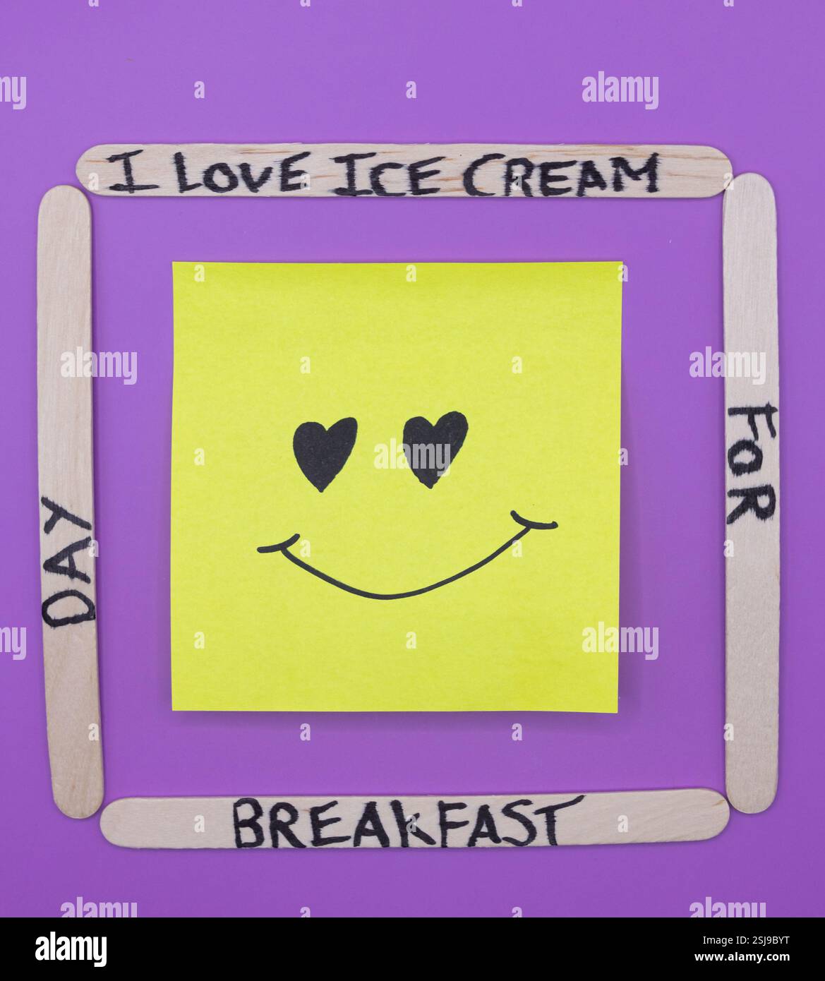 A concept of handwritten popsicle sticks on a purple background and a ...