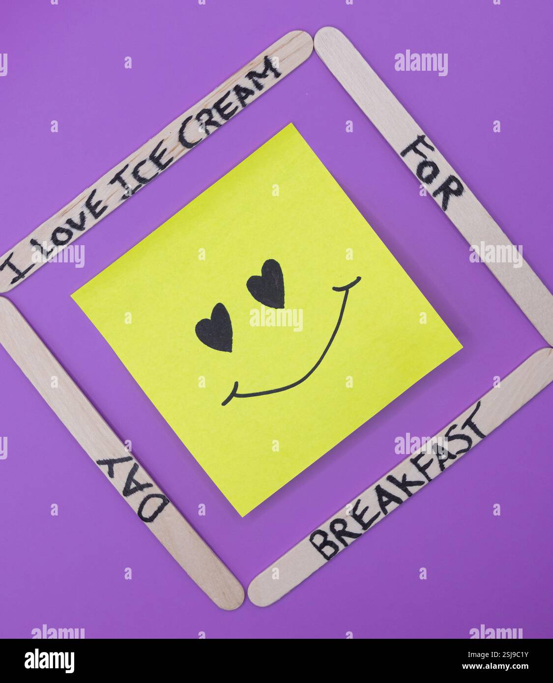 A concept of handwritten popsicle sticks on a purple background and a ...