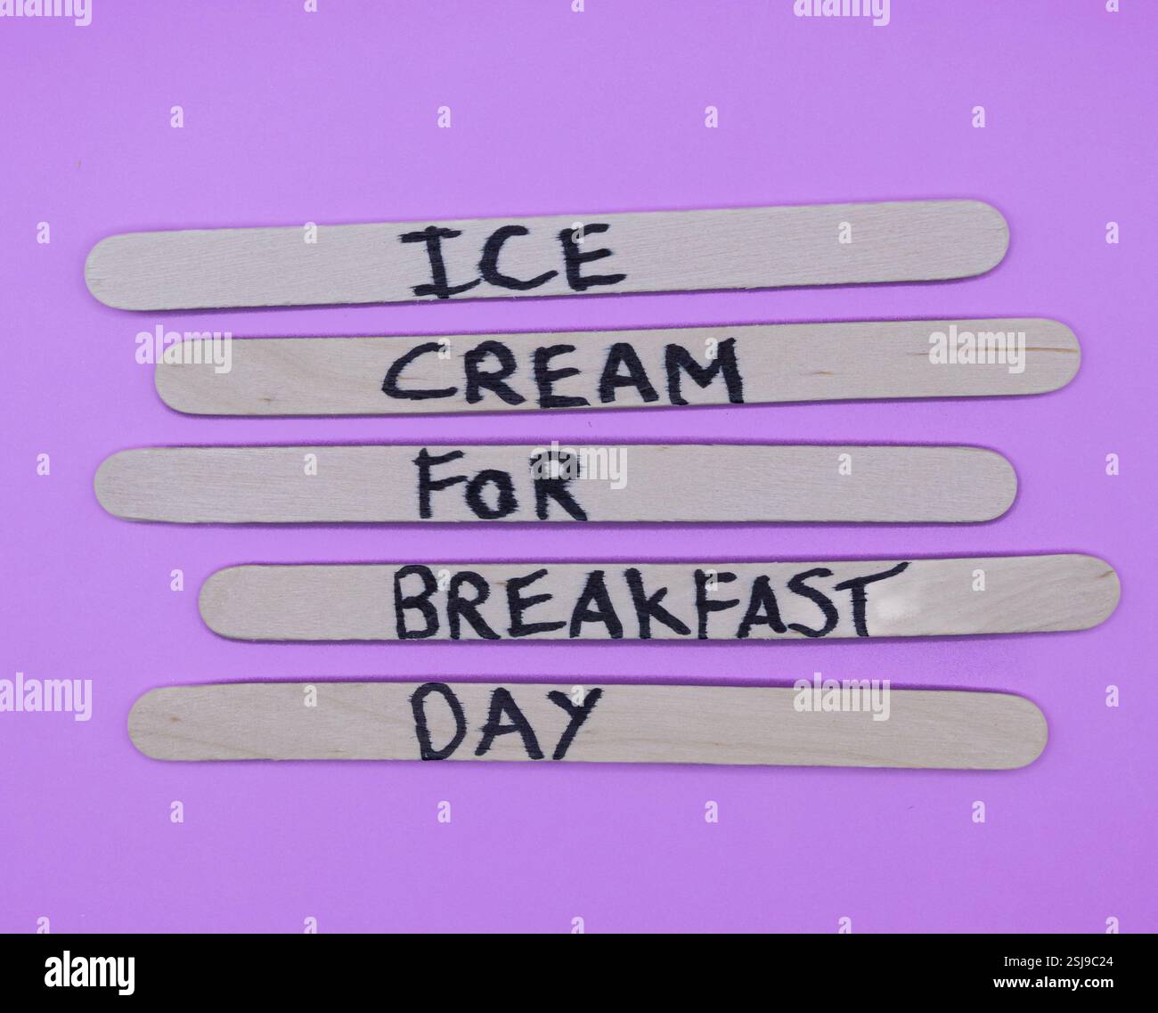A concept of handwritten popsicle sticks on a purple background and a ...