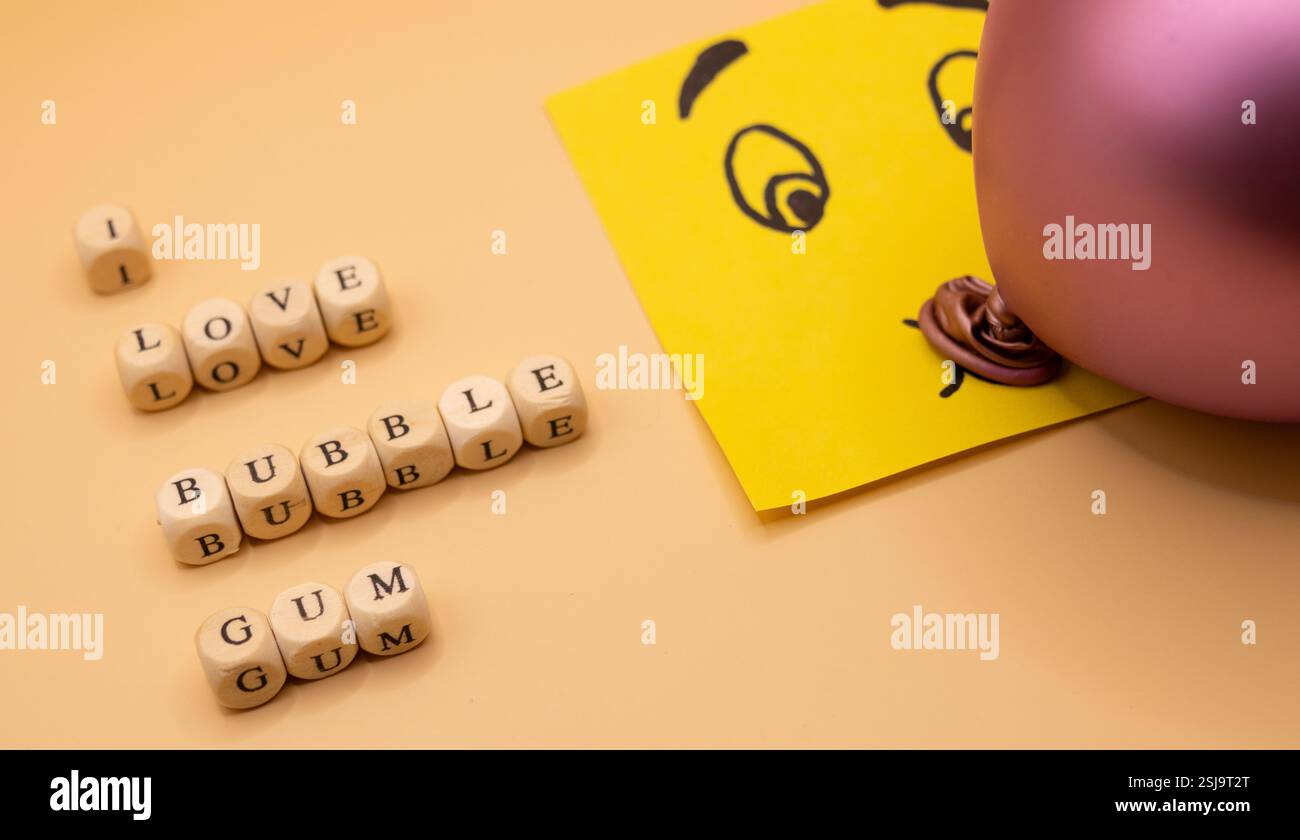 A concept of an emoticon notepad, blowing a bubble of bubble gum on a ...