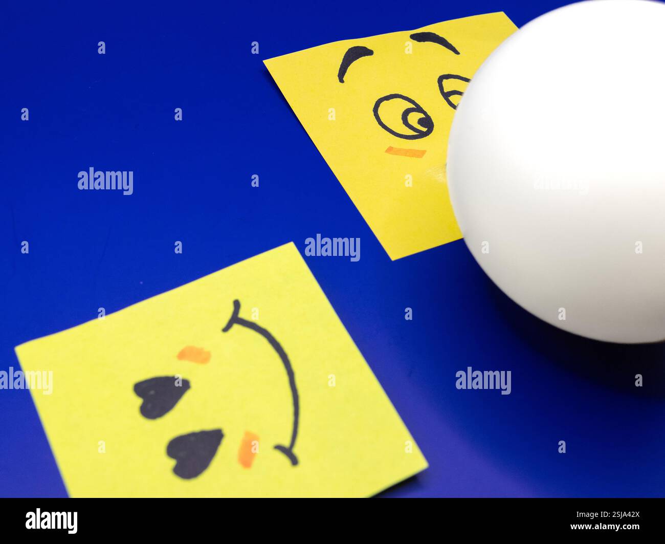 A concept of an emoticon notepad, blowing a bubble of bubble gum for ...
