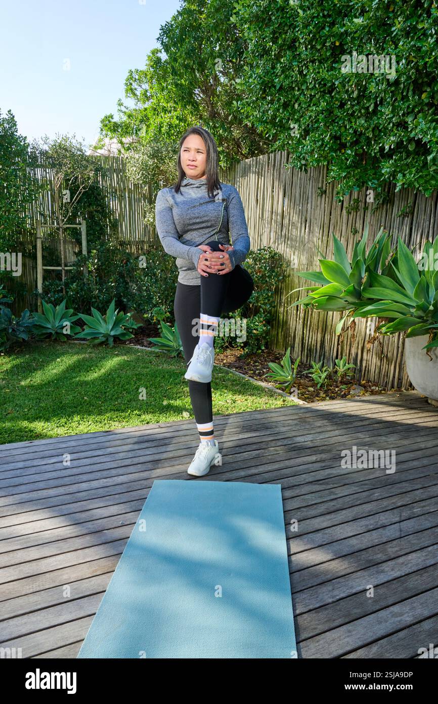 Woman exercising on patio Stock Photo