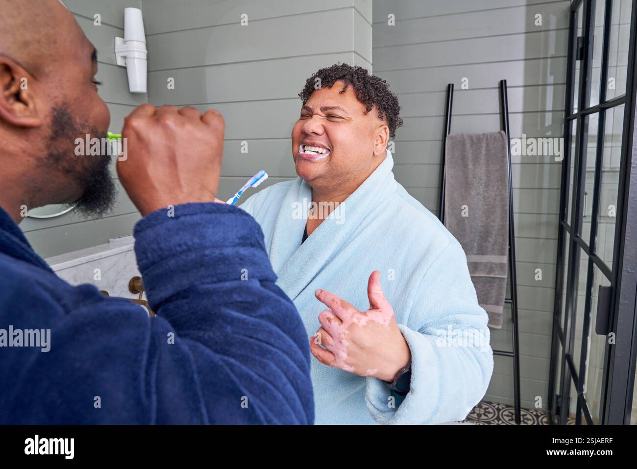 Gay couple brushing teeth Stock Photo