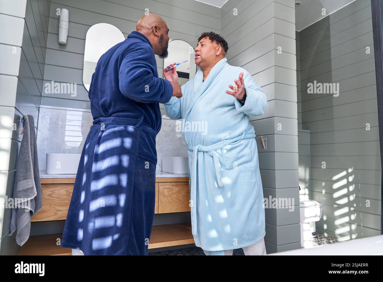 Gay couple brushing teeth Stock Photo