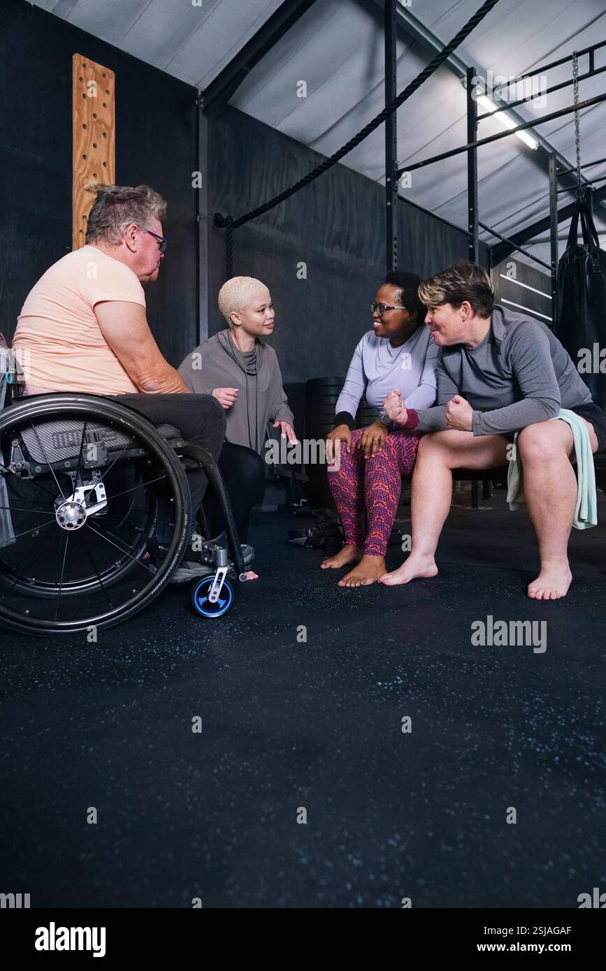 Friends talking in gym Stock Photo