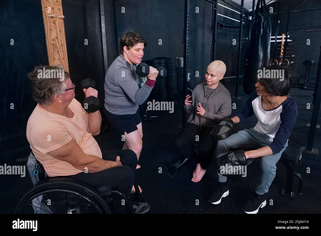 Friends exercising in gym Stock Photo