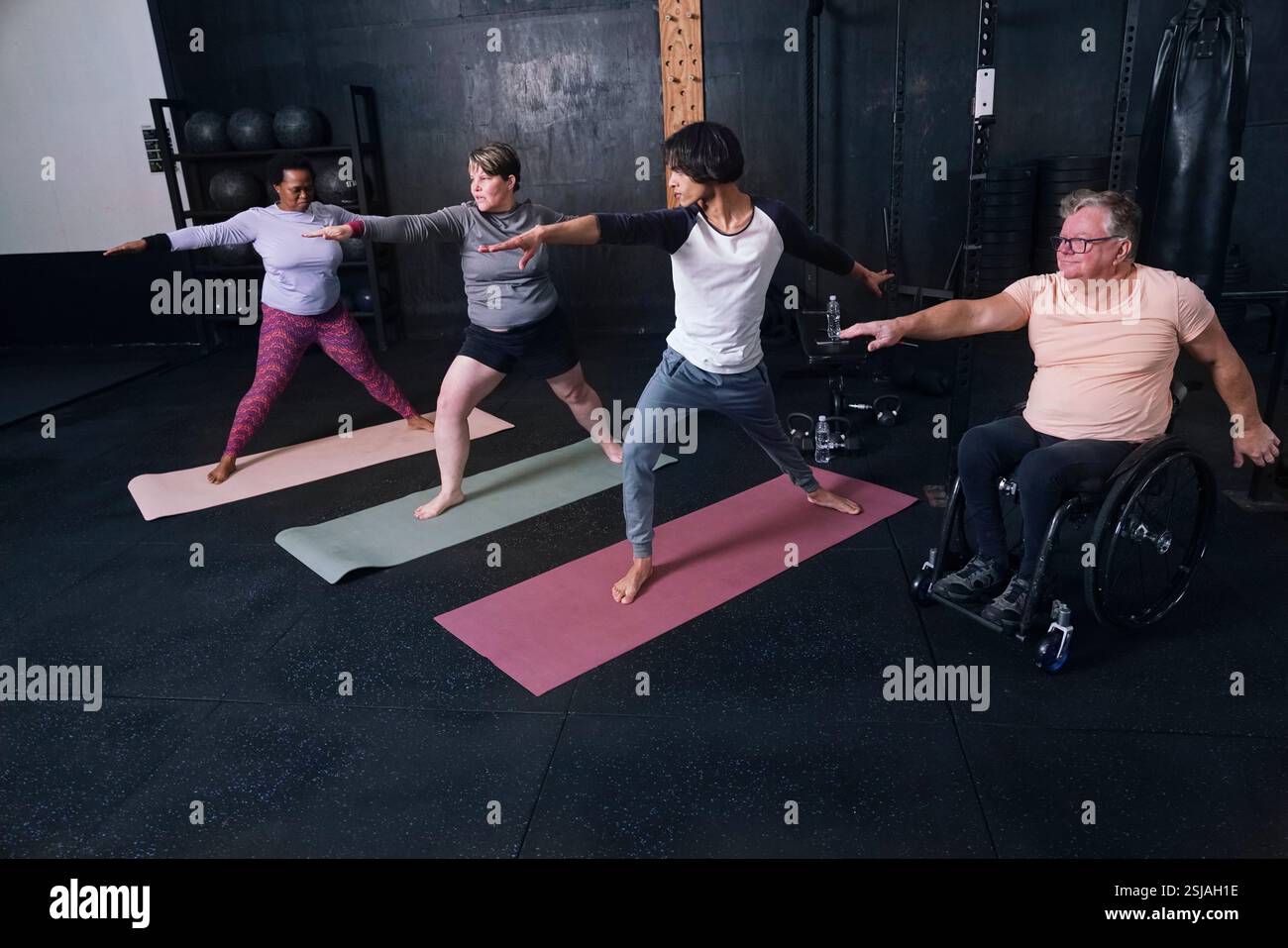 People practicing yoga in gym Stock Photo - Alamy