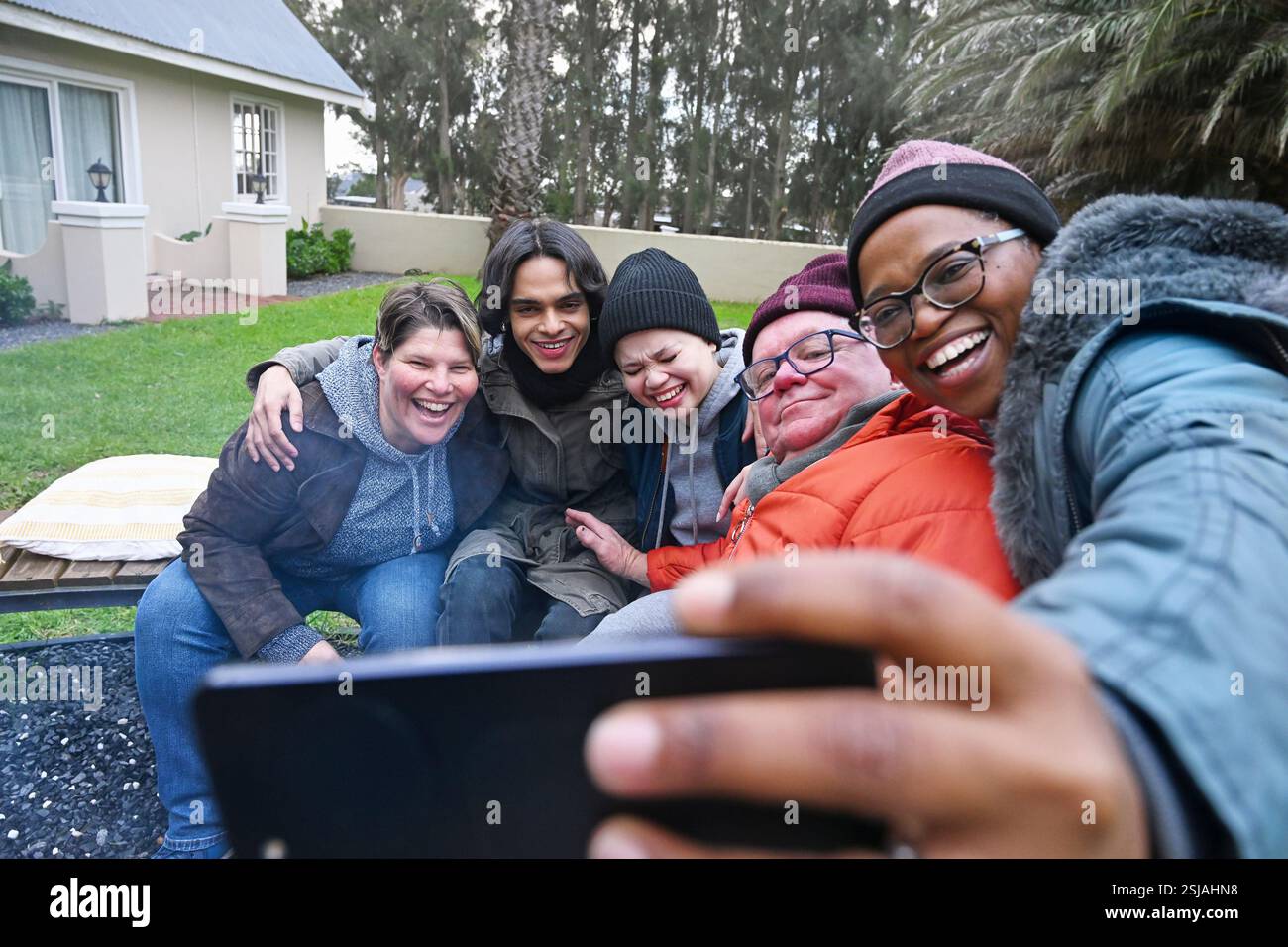 Friends by fire pit in garden Stock Photo