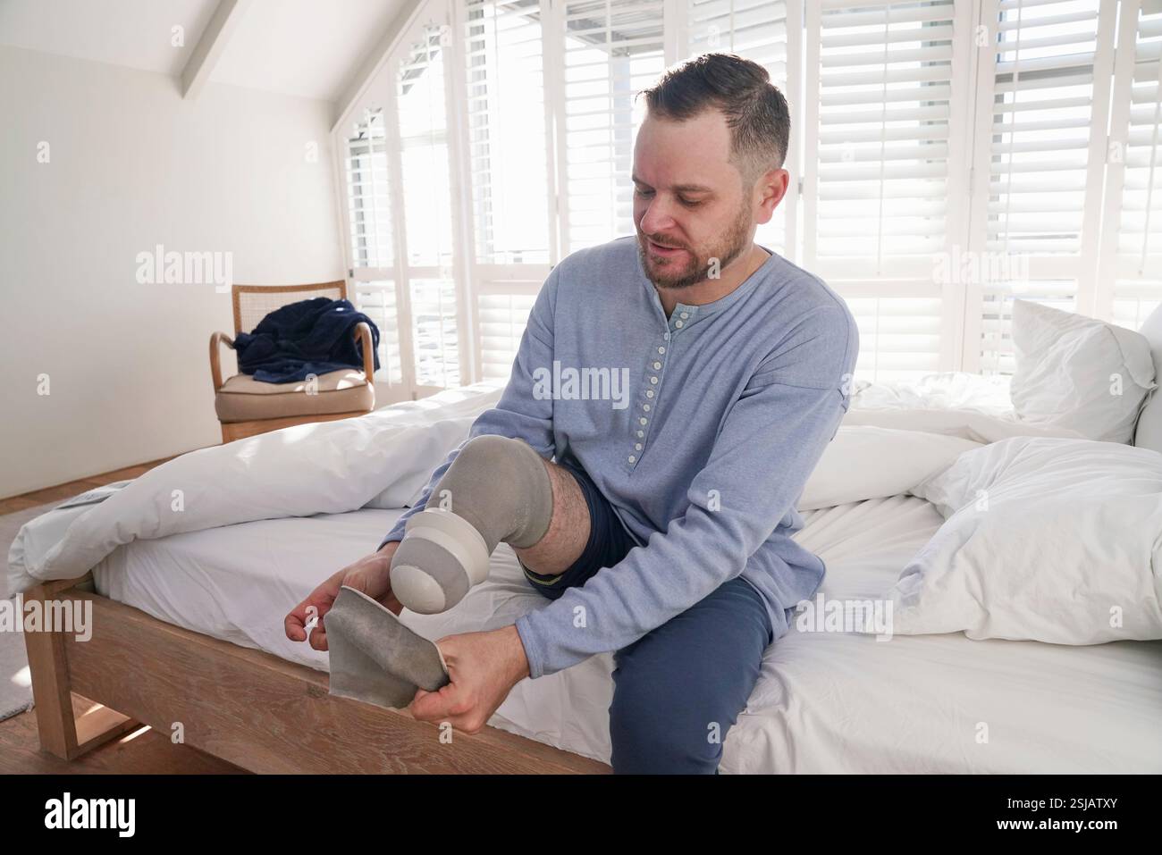 Man attaching leg prosthesis Stock Photo