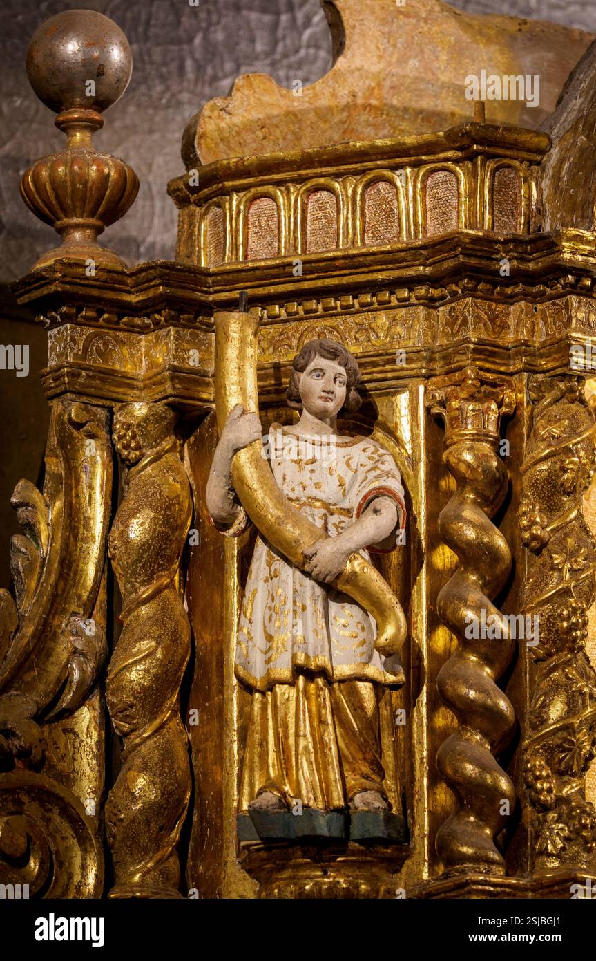 Statue of a figure carrying a cornucopia. Detail of the altar of the church of Saint Thomas of Canterbury, Mur-de-Barrez Aveyron, France. Stock Photo