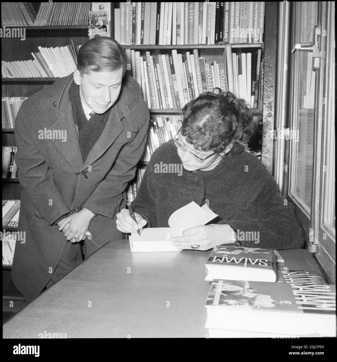 --- Helen Keiser signiert ihr Buch Salaam, 1959#Helen Keiser signs her book Salaam, 1959- RDB BY DUKAS Stock Photo