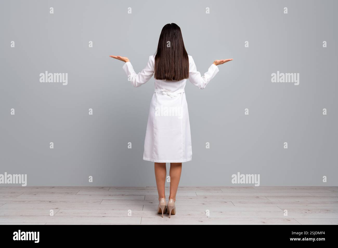Woman standing coat rear view hi-res stock photography and images - Alamy