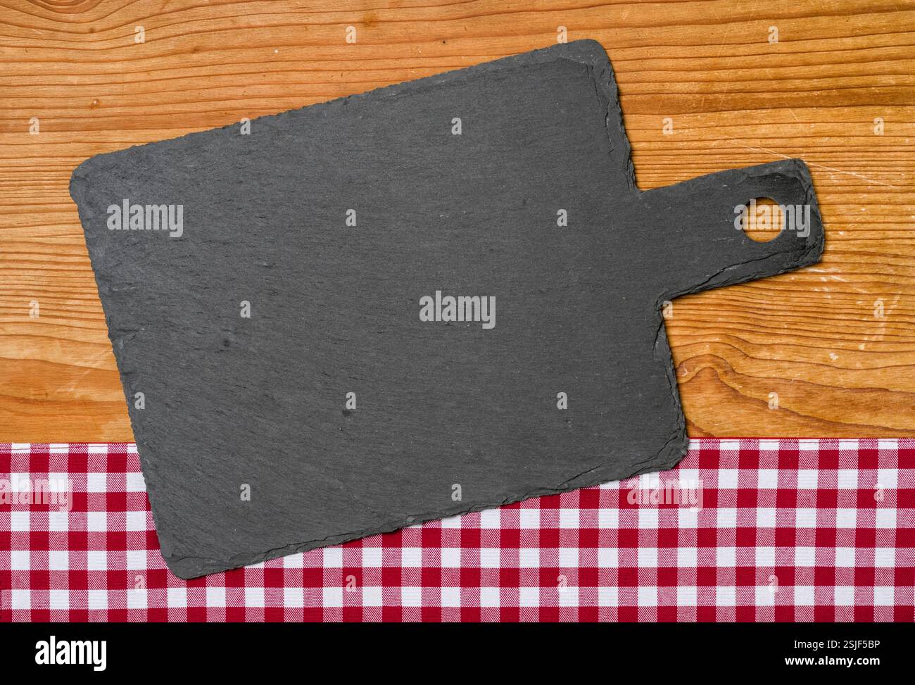 Slate on a red checkered tablecloth Stock Photo