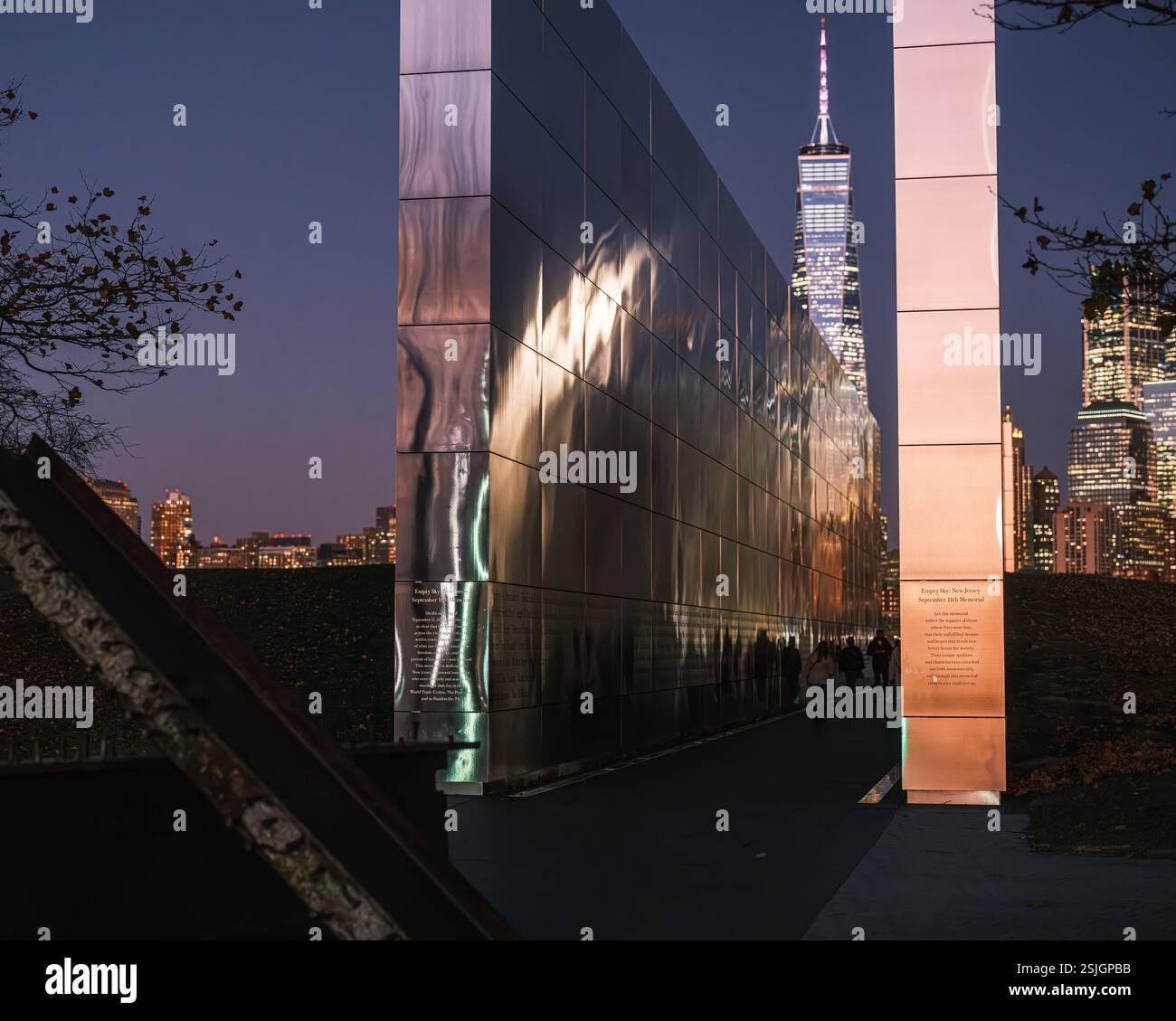 The Empty Sky Memorial in Liberty State Park, New Jersey, illuminated at night with reflections of the Manhattan skyline. Dedicated in 2011. Stock Photo