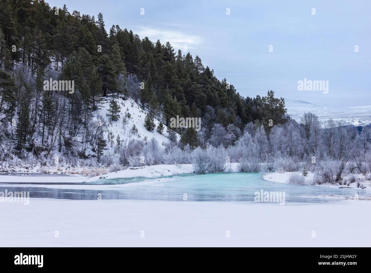 Frozen river in the Norwegian province of Innlandet with blue ice and ...
