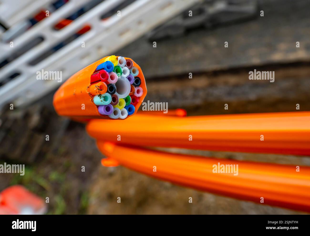Empty conduits for fibre optic cables, protective conduit in orange, containing the empty conduits for the actual fibre optic cables, which are then b Stock Photo