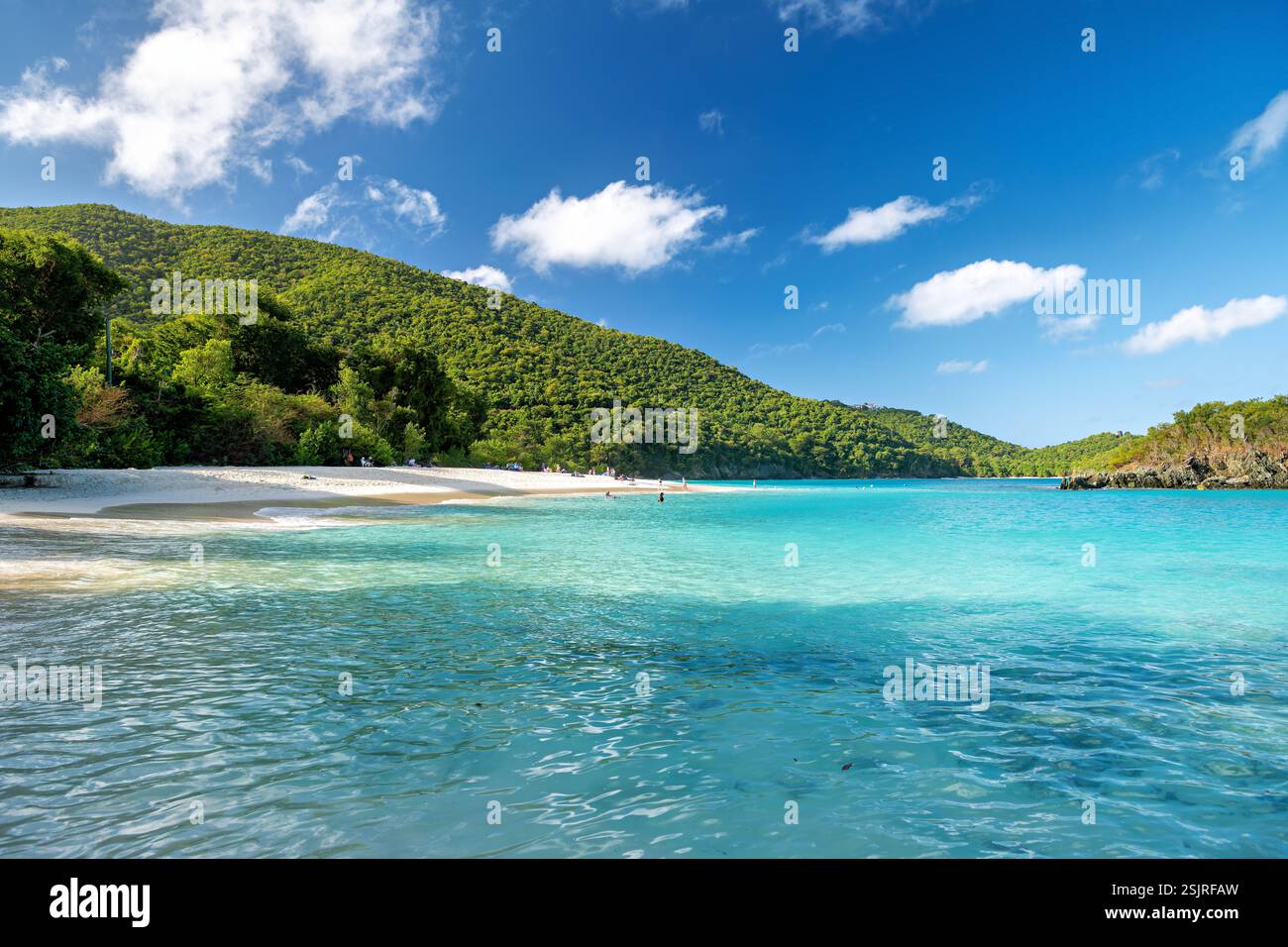 ST. JOHN, U.S. Virgin Islands — Trunk Bay, located within Virgin Islands National Park, features a pristine white sand beach along the island's north shore. The protected bay includes an underwater snorkeling trail that guides visitors past coral reefs. The beach and surrounding waters have been under National Park Service protection since 1956. Stock Photo