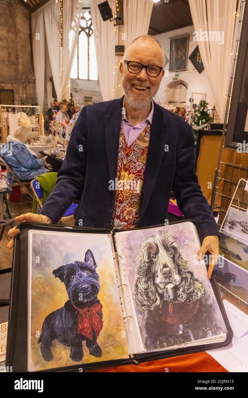 England, Kent, Sandwich, Craft Market, Artist Tony Coates with Samples of his Artwork of Dogs Stock Photo