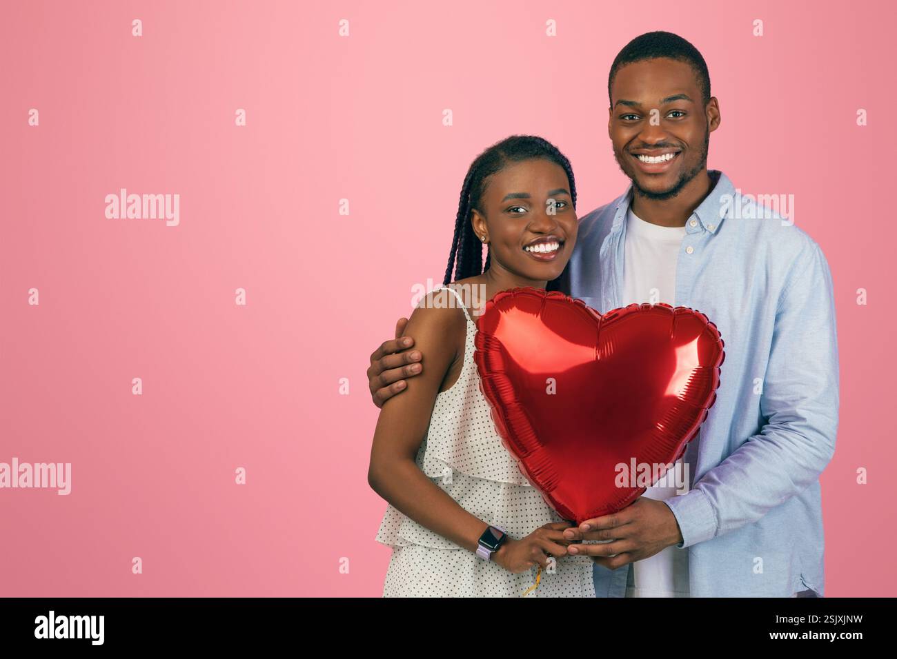 Young Romantic Black Couple Hugging And Holding Heart Shaped Balloon ...