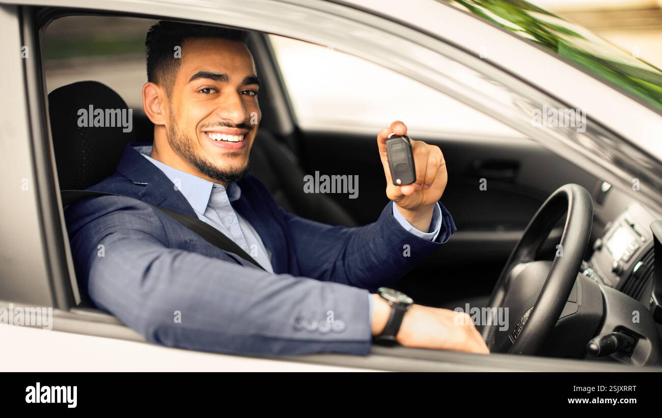 Handsome arabic businessman holding automatic car key Stock Photo