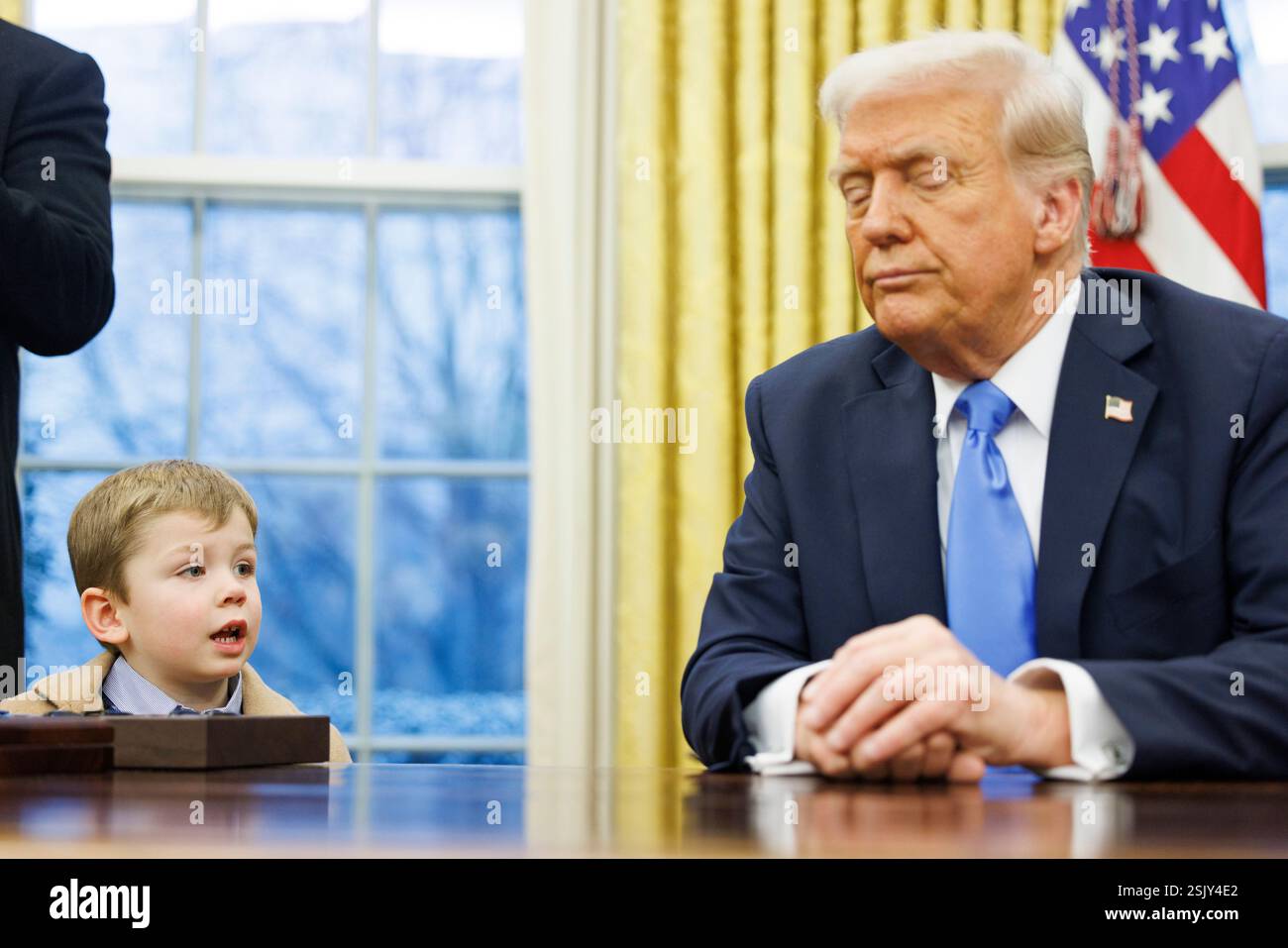 X, the son of Elon Musk, looks at President Donald Trump in the Oval ...