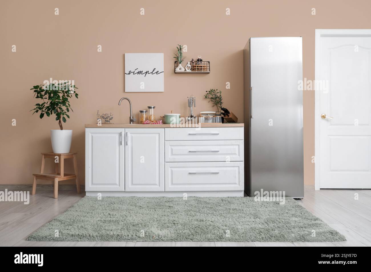 Interior of kitchen with silver fridge, counters and shelf Stock Photo ...